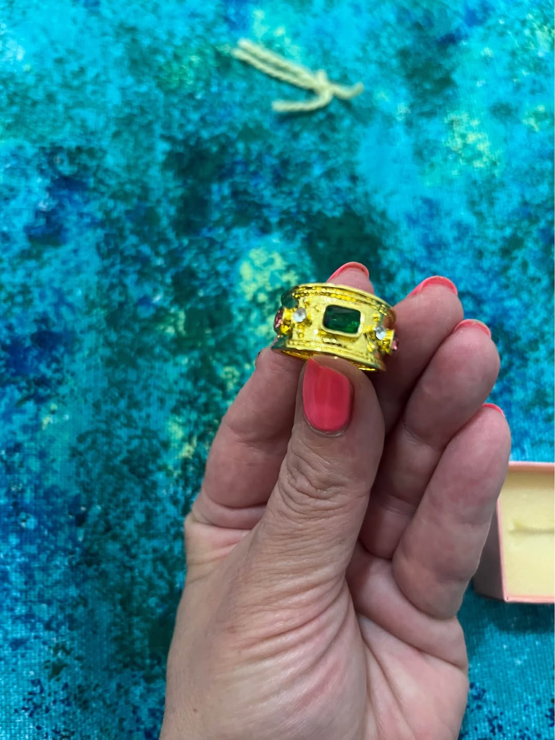 Gold-tone ring with green stone
