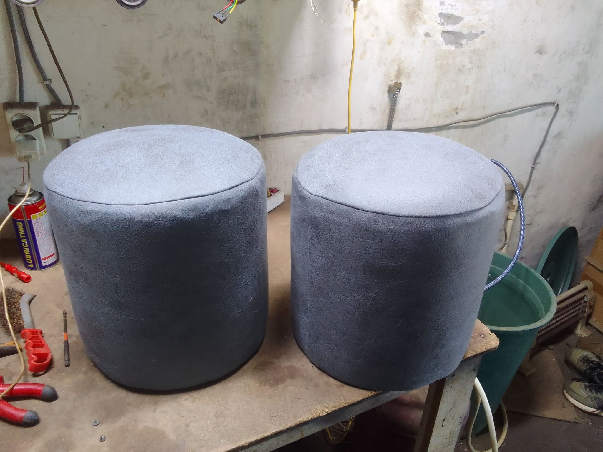 Grey upholstered poufs, two pieces