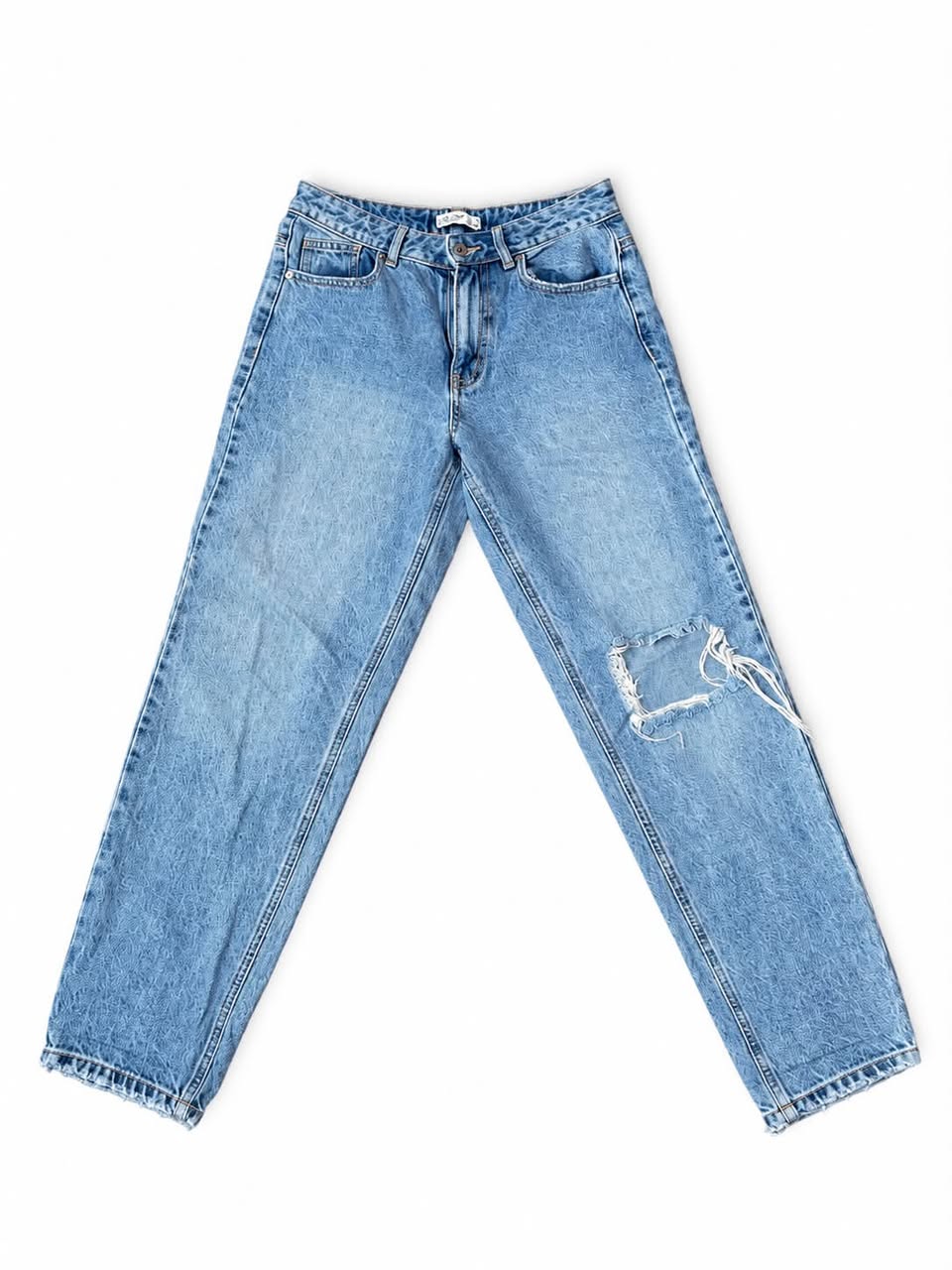 Blue denim jeans with ripped knee
