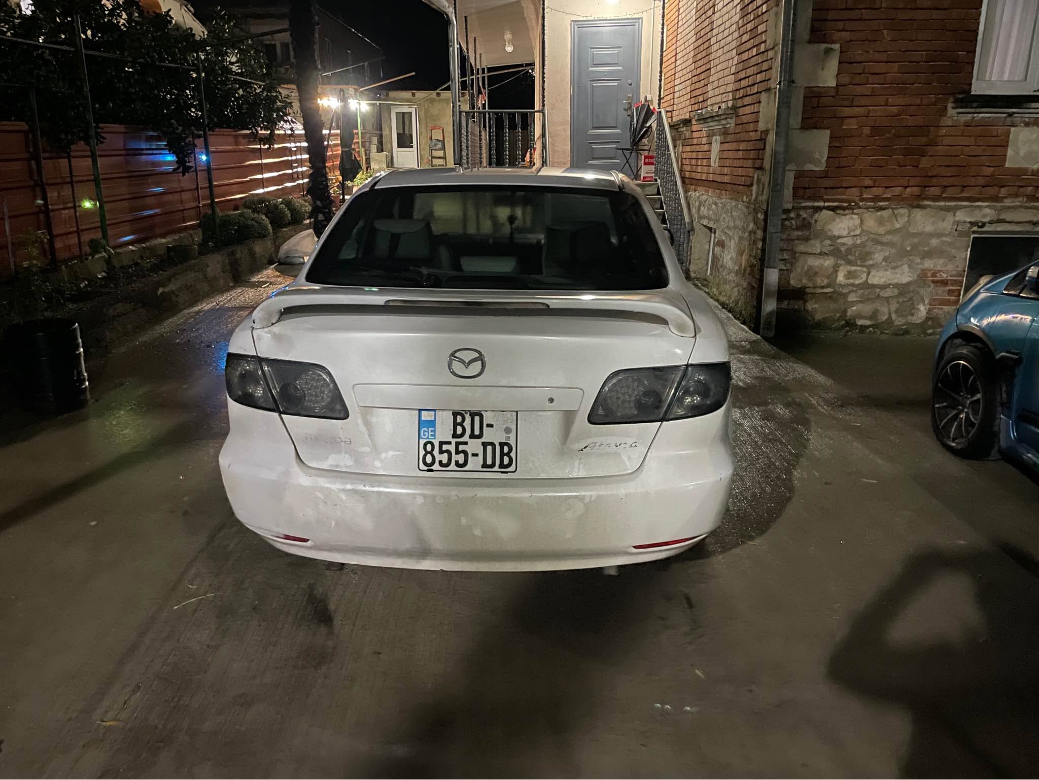 White Mazda sedan, documents in order
