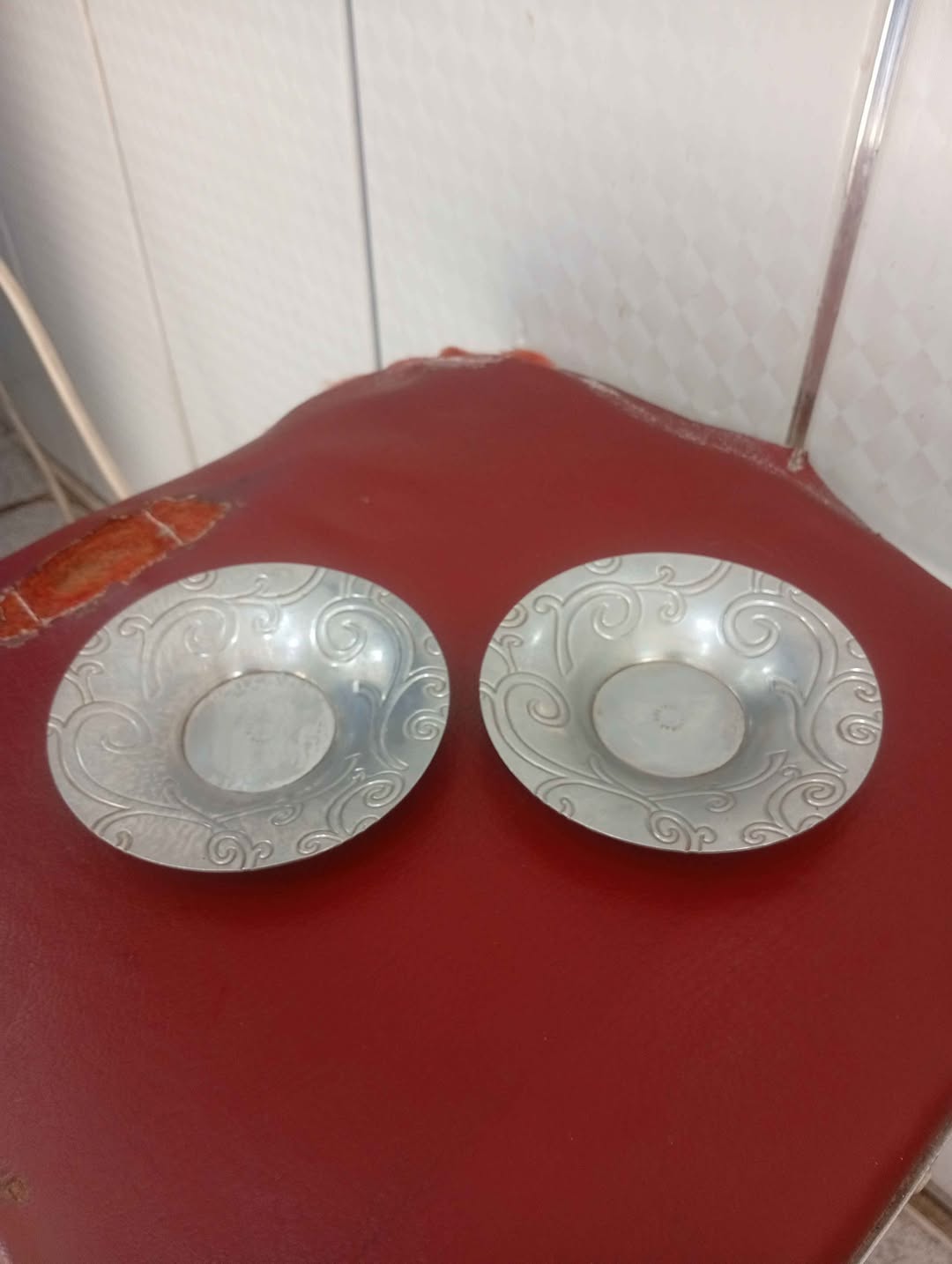 Set of 2 embossed metal saucers