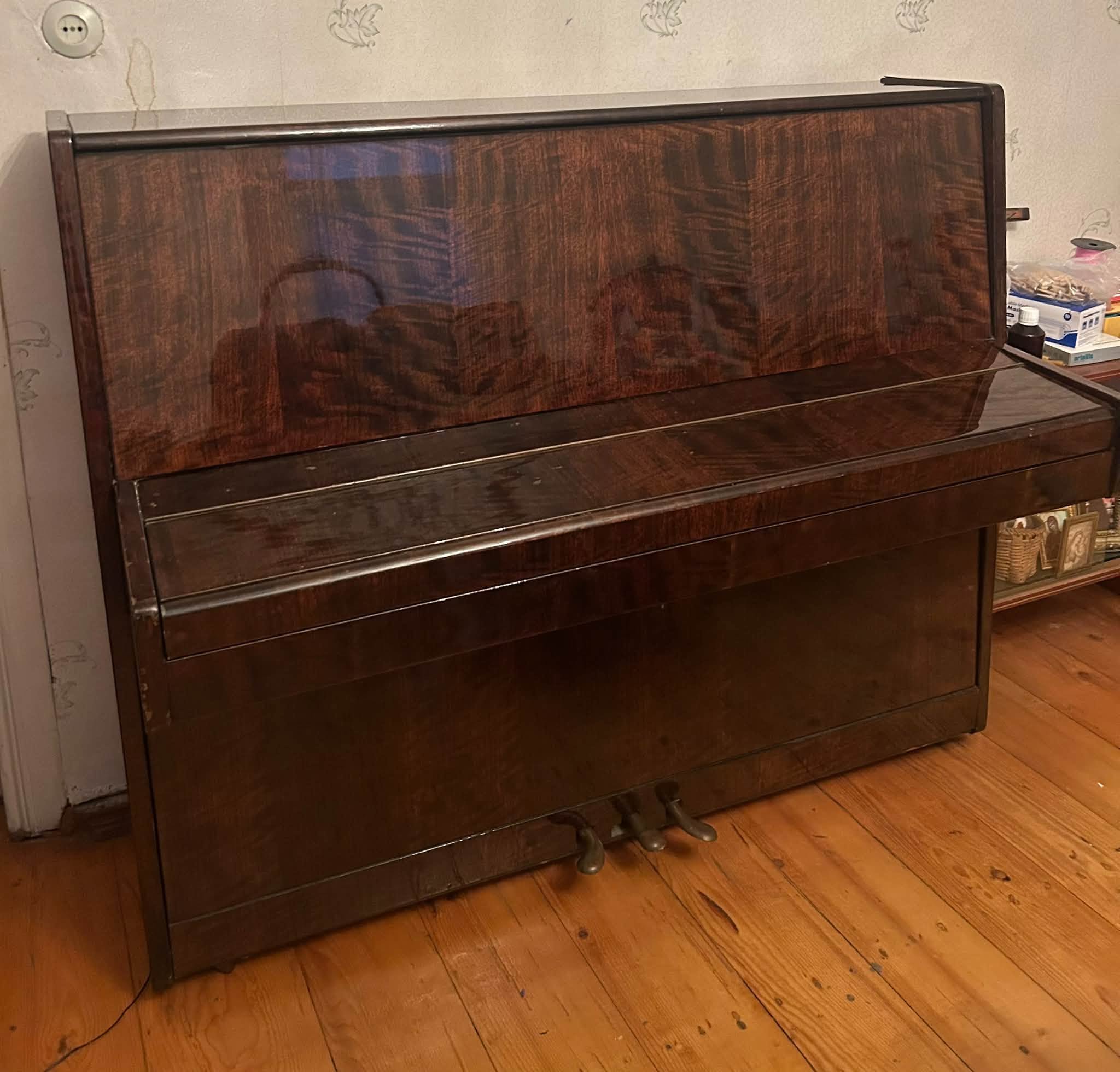 Upright piano with a wood finish from a private home