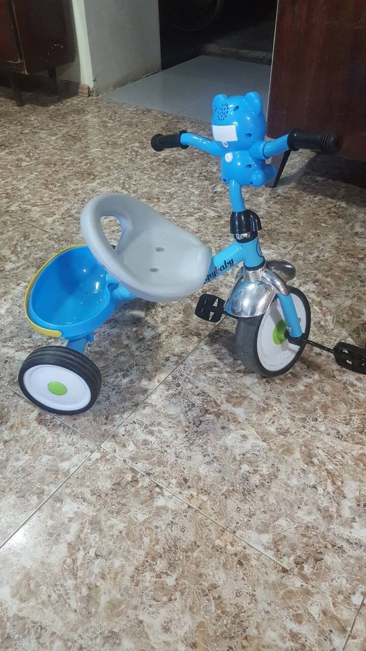 Blue three-wheeled child's bicycle