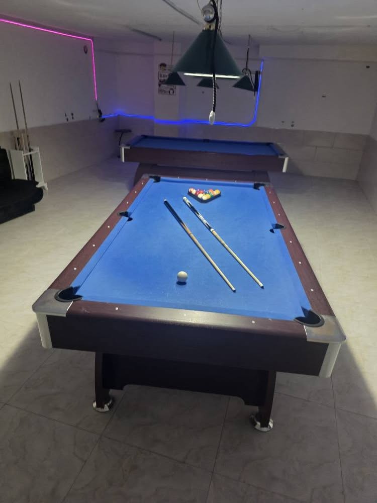 Billiard table with balls and cues